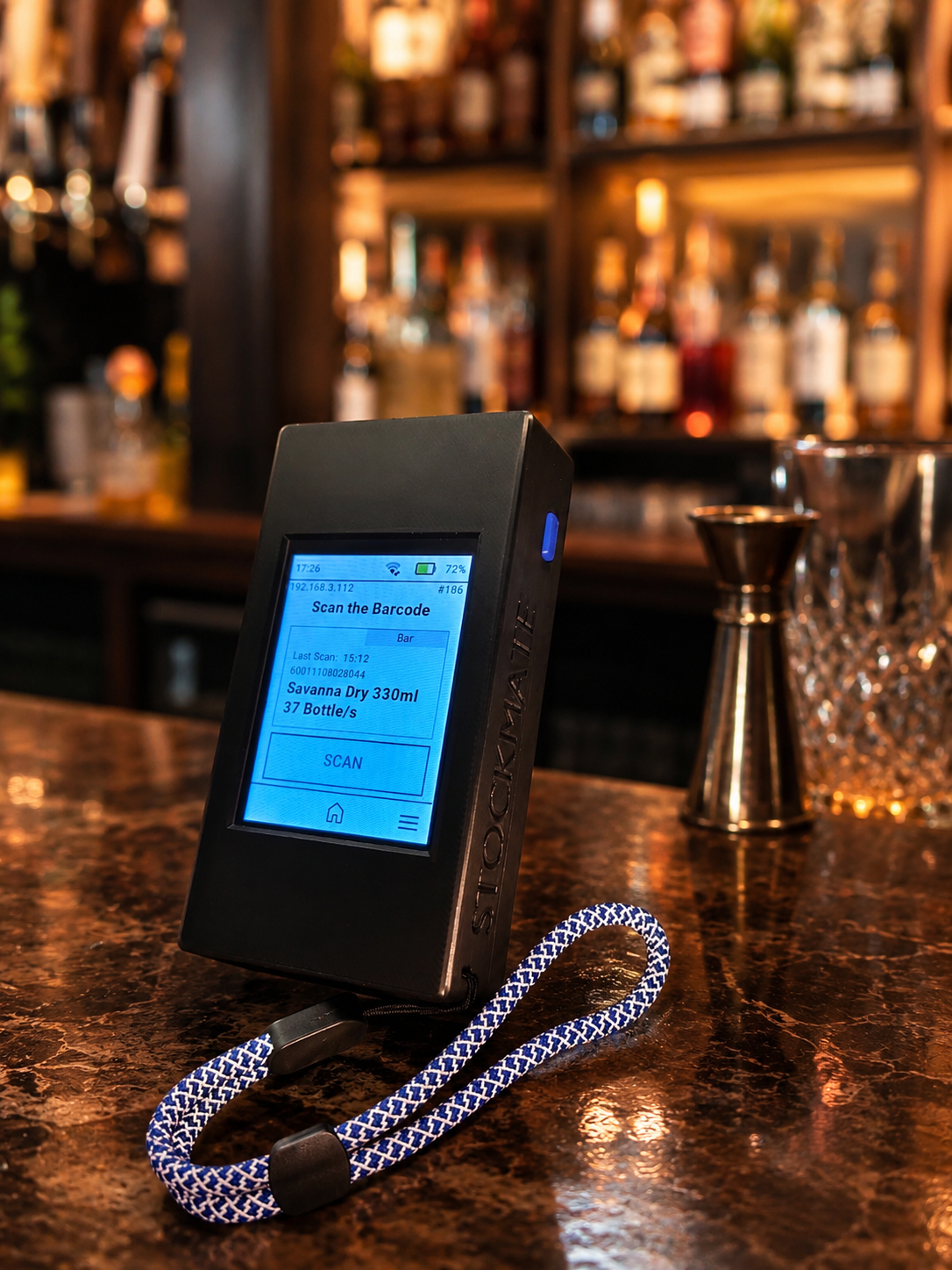 Stockmate Handheld Counter on a bar counter ready to scan full bottles